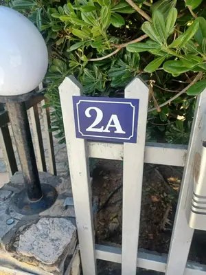 a sign with the number on it in front of plants at relax studio appartment in Porto Rafti
