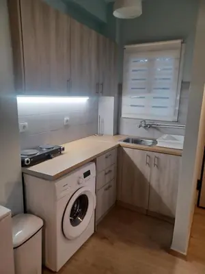 a kitchen with a washing machine and a sink at relax studio appartment in Porto Rafti