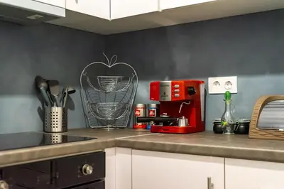 a kitchen with a counter top with a red appliance at Acropolis Horizon by WeHost Athens in Athens
