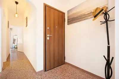 a hallway with a wooden door in a house at Acropolis Horizon by WeHost Athens in Athens