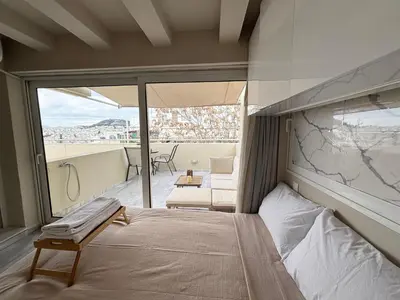 a bedroom with a bed and a balcony at Mania's Studio by Lycabetus in Athens