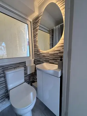 a bathroom with a toilet and a sink and a mirror at Mania's Studio by Lycabetus in Athens