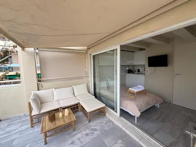 a living room with a couch and a bedroom at Mania's Studio by Lycabetus in Athens