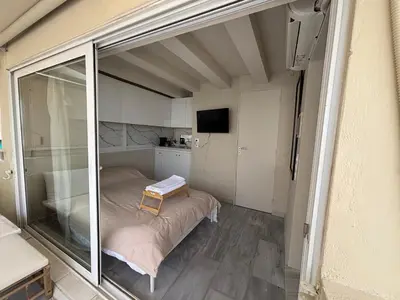 a small room with a bed and a sliding glass door at Mania's Studio by Lycabetus in Athens