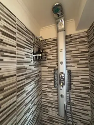 a shower in a bathroom with a glass wall at Mania's Studio by Lycabetus in Athens