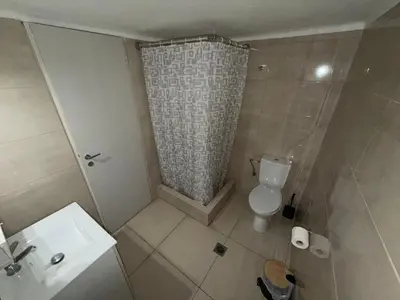 a bathroom with a shower and a toilet and a sink at Cavo D' Oro in Piraeus