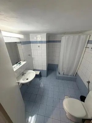 a bathroom with a toilet and a sink and a shower at Cavo D' Oro in Piraeus