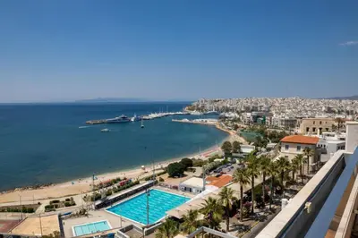 a view of a beach and a swimming pool at Cavo D' Oro in Piraeus