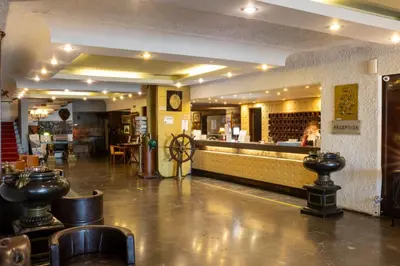 a restaurant with a bar with chairs and a counter at Cavo D' Oro in Piraeus