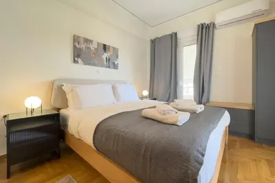 a bedroom with a bed with two towels on it at Cozy Apartment with Office - 19min to Athens Center in Athens