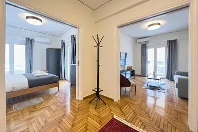 a bedroom with a bed and a living room at Cozy Apartment with Office - 19min to Athens Center in Athens