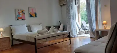 a bedroom with a bed with two stuffed animals on it at Camellia Apartment ATHENS CENTER 5BD, 2 BATHS in Athens