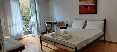 a bedroom with a bed with towels on it at Camellia Apartment ATHENS CENTER 5BD, 2 BATHS in Athens