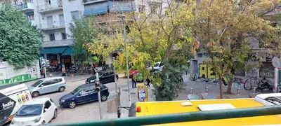 a busy city street with cars parked on the street at Camellia Apartment ATHENS CENTER 5BD, 2 BATHS in Athens