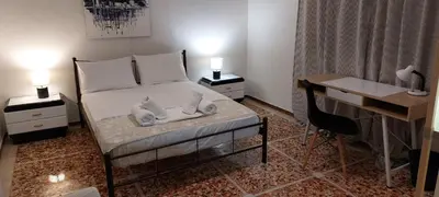 a bedroom with a bed with a desk and a desk at Camellia Apartment ATHENS CENTER 5BD, 2 BATHS in Athens