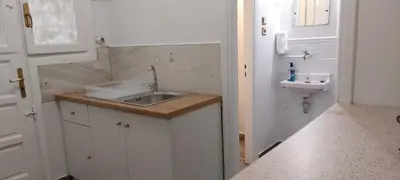 a small kitchen with a sink and a toilet at Camellia Apartment ATHENS CENTER 5BD, 2 BATHS in Athens
