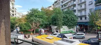 a view of a city street with a yellow truck at Camellia Apartment ATHENS CENTER 5BD, 2 BATHS in Athens