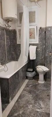 a bathroom with a tub and a toilet and a sink at Camellia Apartment ATHENS CENTER 5BD, 2 BATHS in Athens