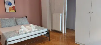 a room with a bed with towels on it at Rose Apartment Athens Center , 5BD, 2 BATH in Athens