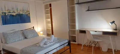 a small bedroom with a bed and a desk at Rose Apartment Athens Center , 5BD, 2 BATH in Athens