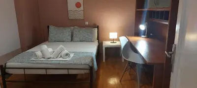 a small bedroom with a bed and a desk at Rose Apartment Athens Center , 5BD, 2 BATH in Athens