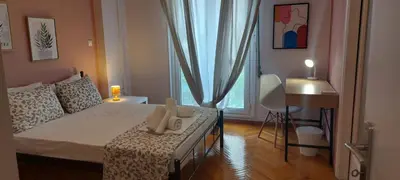 a small bedroom with a bed and a window at Rose Apartment Athens Center , 5BD, 2 BATH in Athens