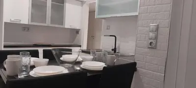 a kitchen with a table with plates and glasses on it at Rose Apartment Athens Center , 5BD, 2 BATH in Athens