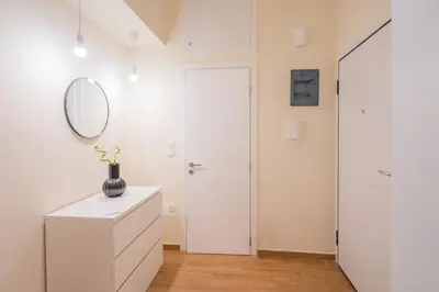 a white room with a mirror and a white dresser at Exarcheia's Bliss in Athens