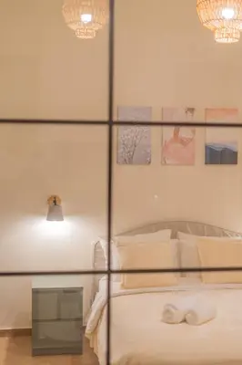 a bedroom with a bed with a glass wall at Exarcheia's Bliss in Athens