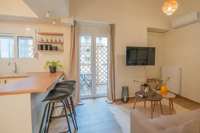 a kitchen and living room with a table and chairs at Exarcheia's Bliss in Athens
