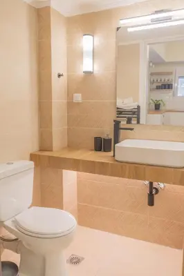 a bathroom with a toilet and a sink and a mirror at Exarcheia's Bliss in Athens
