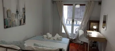 a bedroom with a bed and a desk and a window at Vintage Apartment Athens Center 6BD-2BATH in Athens