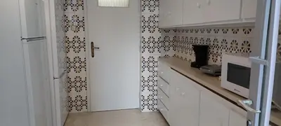a kitchen with white cabinets and a tiled wall at Vintage Apartment Athens Center 6BD-2BATH in Athens