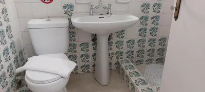 a bathroom with a toilet and a sink at Vintage Apartment Athens Center 6BD-2BATH in Athens