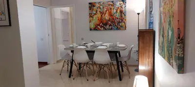 a dining room table with white chairs and a painting at Vintage Apartment Athens Center 6BD-2BATH in Athens