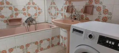 a bathroom with a sink and a washing machine at Vintage Apartment Athens Center 6BD-2BATH in Athens