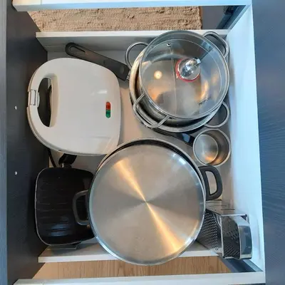 a drawer full of pots and pans in a box at Andromeda-The Airport Home in Markopoulo