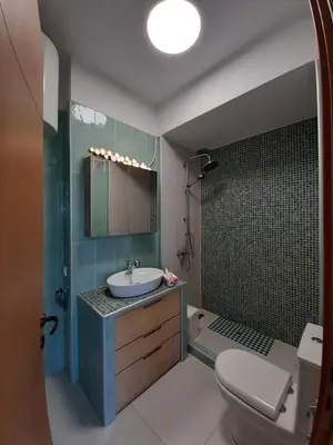 a bathroom with a sink and a toilet at Andromeda-The Airport Home in Markopoulo