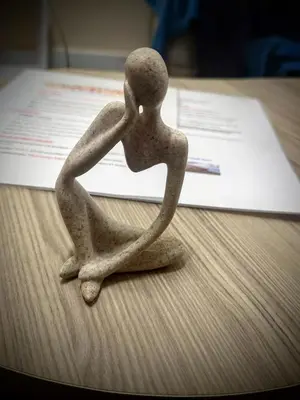 a statue of a person sitting on a table at Central Piraeus port apartment in Piraeus