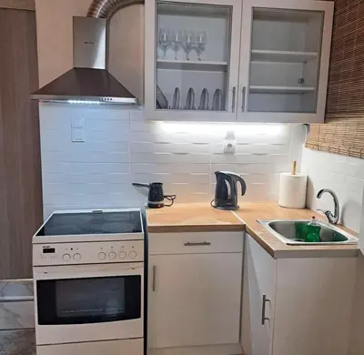 a small kitchen with a stove and a sink at Central Piraeus port apartment in Piraeus