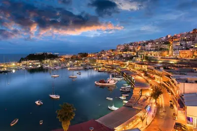 a harbor with boats in the water at night at Central Piraeus port apartment in Piraeus