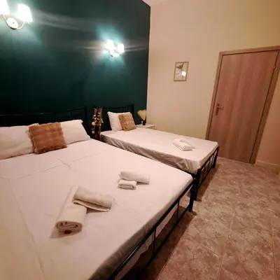 two beds in a room with towels on them at Central Piraeus port apartment in Piraeus