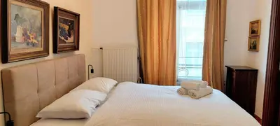a bed with a teddy bear sitting on top of it at Marvelous apartment in Plaka in Athens