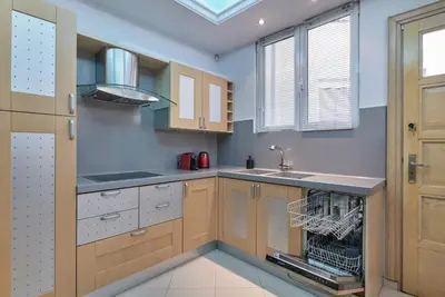 a kitchen with wooden cabinets and a sink at Marvelous apartment in Plaka in Athens