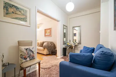 a living room with a blue couch and a chair at Piraiki Sea View Apt, 2bdrms, 4 pers by MPS in Piraeus