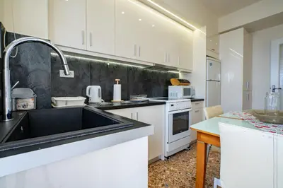 a kitchen with a sink and a counter top at Piraiki Sea View Apt, 2bdrms, 4 pers by MPS in Piraeus