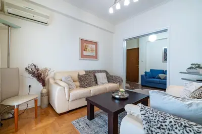 a living room with a couch and a table at Piraiki Sea View Apt, 2bdrms, 4 pers by MPS in Piraeus