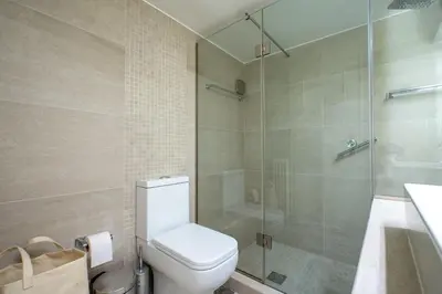 a bathroom with a toilet and a glass shower at Piraiki Sea View Apt, 2bdrms, 4 pers by MPS in Piraeus