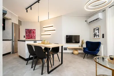 a kitchen with a table and chairs in a room at Stylish 1BD Apt in Elliniko in Athens