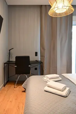 a bedroom with a bed with towels on it at New 2BR apt in Kallithea in Athens